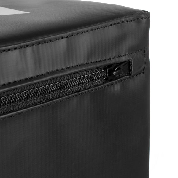 Close-up of the black fabric surface on the SMAI WOD Box Pro - Foam Plyo Box (20"/24"/30") by SMAI, showing a visible zipper, detailed stitching, and slightly reflective competition-grade material.