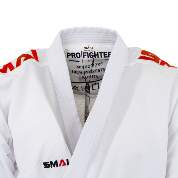A close-up of the SMAI WKF Karate Uniform Pack—8oz Premium Kumite Gi Pro Fighter shows "SMAI" and "PRO FIGHTER" on the collar, red "SMAI" logos on shoulders/chest. This lightweight karate uniform is made from 100% polyester.