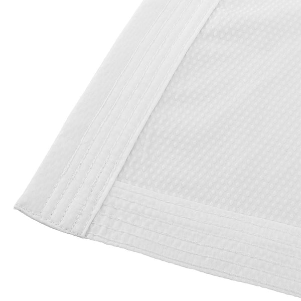 Close-up of the SMAI WKF Karate Uniform Pack - 8oz Premium Kumite Gi - Pro Fighter, showcasing detailed stitching and textured white fabric.