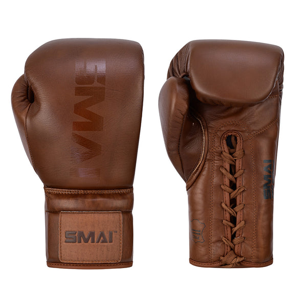 The SMAI Pro Series Leather Lace-Up Boxing Glove in Antique Brown is shown: one displays the palm with laces, the other shows the branded back. Both feature velcro wrist straps and a smooth, classic design for superior impact absorption.