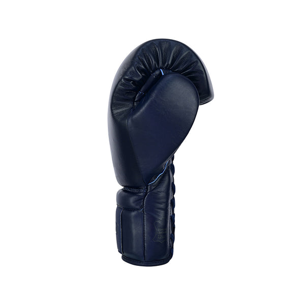 The SMAI Pro Series Leather Lace-Up Boxing Glove in navy blue stands upright on a white background, palm side visible with curved padding and detailed stitching for enhanced impact absorption.