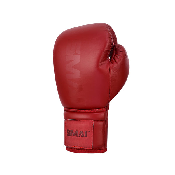 A single Pro Series Leather Lace-Up Boxing Glove in crimson red by SMAI, featuring the brand name on the wrist and glove surface, is shown against a plain white background.