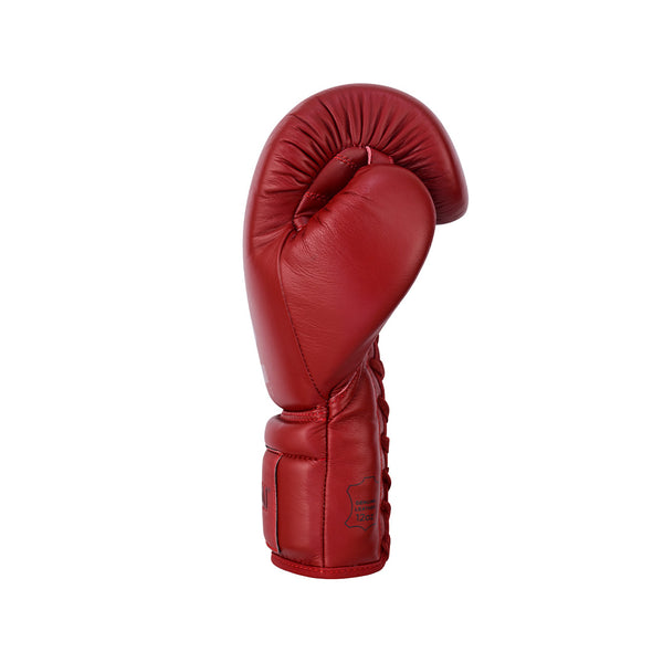 A single SMAI Pro Series Leather Lace-Up Boxing Glove in Crimson Red stands upright against a plain white background.