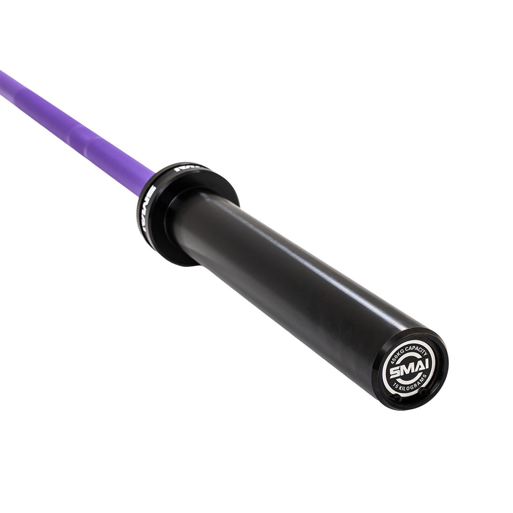 Close-up of the SMAI Barbell - Purple Ceramic Coat - 15kg, featuring a black sleeve, purple shaft, and branded end cap. The rust-resistant barbell showcases its durable sleeve and end cap design.