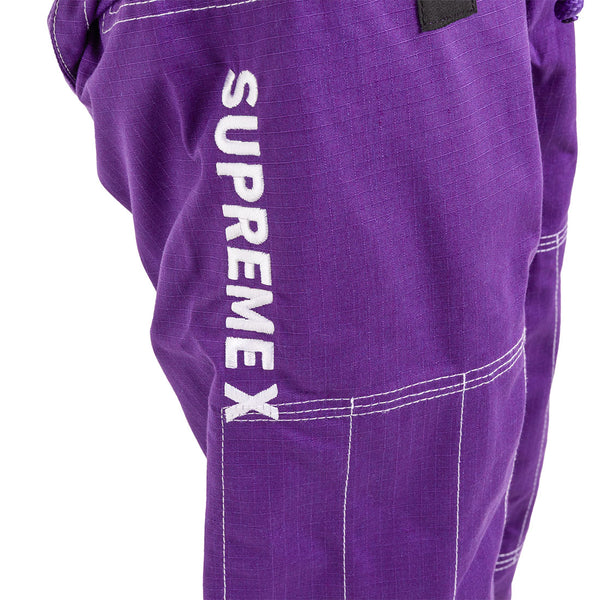 Close-up of the purple Supreme X Brazilian Jiu Jitsu Uniform by SMAI, featuring white stitching and "SUPREMEX" embroidered in white text vertically along the side.