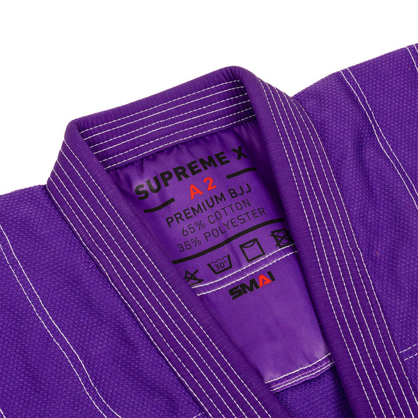 Close-up of the Supreme X Brazilian Jiu Jitsu Uniform - Purple by SMAI, showing its durable pearl weave fabric, white stitching, collar, and an inner label with "SUPREME X, A2, PREMIUM BJJ, 65% COTTON, 35% POLYESTER.