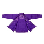 The SMAI Supreme X Brazilian Jiu Jitsu Uniform - Purple is displayed flat with sleeves extended and front open, showcasing the inner lining and pearl weave stitching details against a white background.