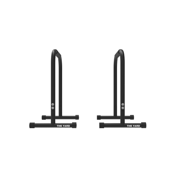 Two black SMAI Tall Parallettes from "The Yard" collection, featuring the brand name on the base, are shown side by side on a white background—ideal gym equipment for dips, push-ups, and other bodyweight exercises.