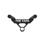 The Yard - Core Trainer / Landmine Parallel Row Handle by SMAI features two grips and a centered ring, with "THE YARD" in bold white on the connecting bar, shown on a white background.