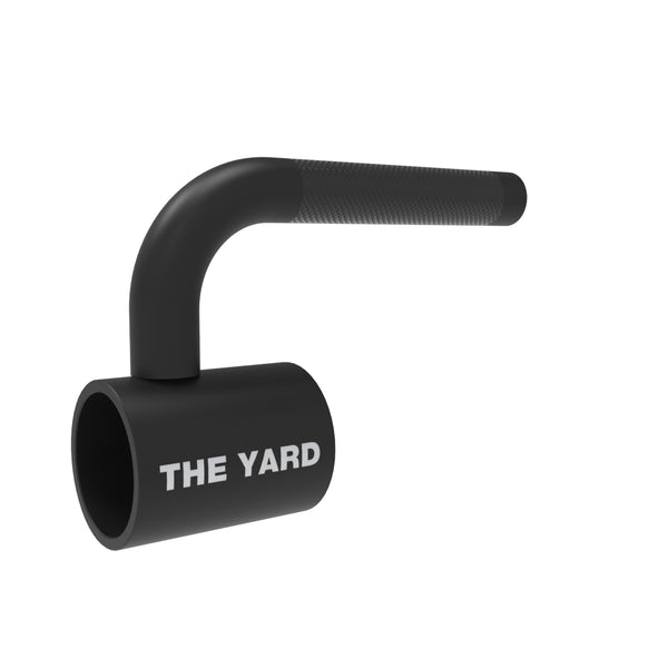 The SMAI The Yard - Single Barbell Handle is a black, cylindrical metal landmine accessory with a textured grip and "THE YARD" printed in white. Its right-angle bend makes it a versatile core trainer for strength workouts.