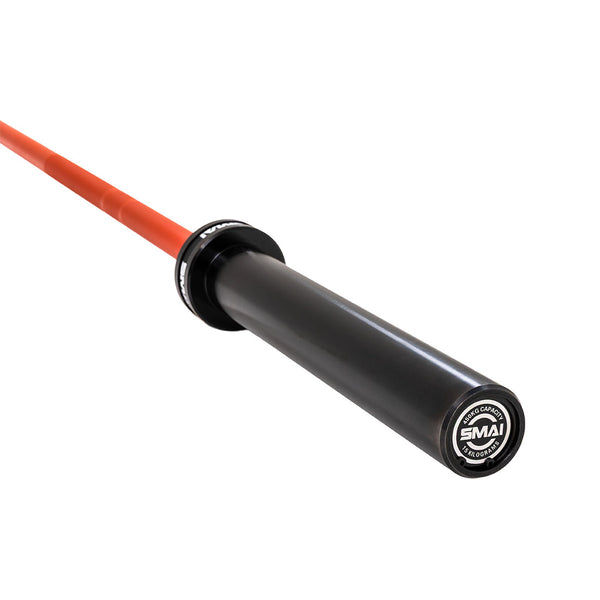 A close-up of the SMAI Barbell - Red Ceramic Coat - 15kg shows its black sleeve, vivid red shaft, and branded end cap, emphasizing the premium ceramic coating and quality finish.