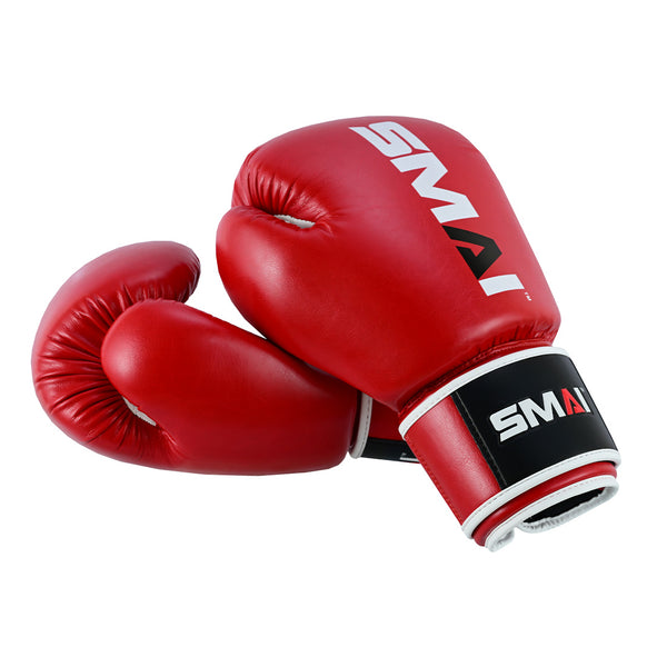 A pair of Essentials Red Boxing Gloves by SMAI, featuring the brand's logo on the top and wrist straps, are shown overlapping on a white background.