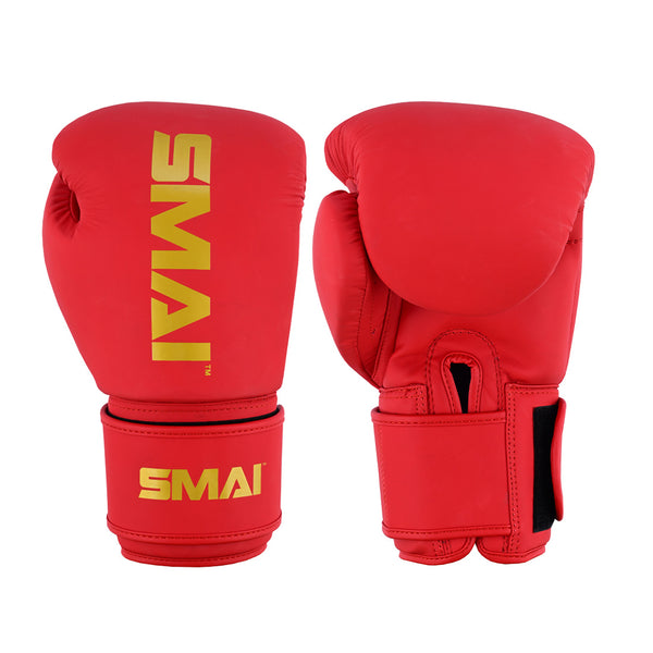 A pair of SMAI Gold Series Boxing Gloves in Red/Gold, designed for shock protection with secure wrist straps and bold yellow branding, are displayed showing both the palm and back sides.