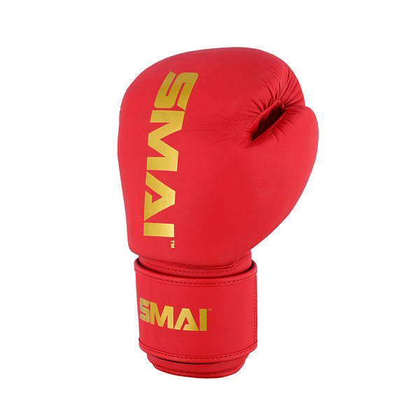 A SMAI Gold Series Boxing Glove - Red/Gold stands upright against a plain white background, featuring gold "SMAI" branding on the top and wrist strap and designed for ultimate shock protection.