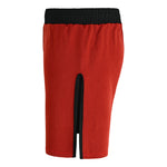 The SMAI Hybrid MMA Grappling Shorts in red and black feature a knee-length design, black elastic waistband, and a center-back black vertical slit, inspired by durable training gear. Displayed on a white background.