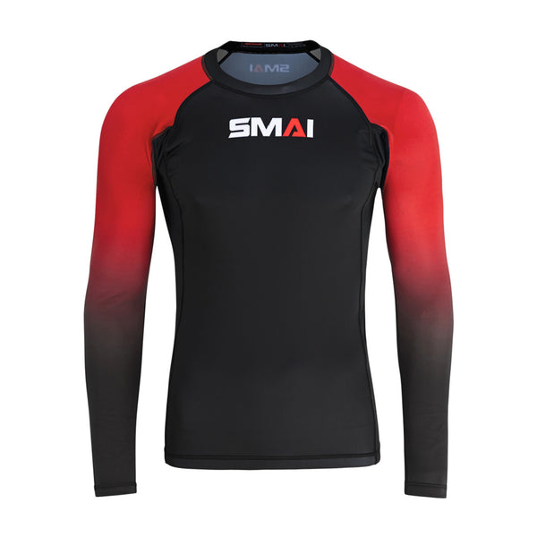 The SMAI Long Sleeve Rash Guard - Red features a black body, red and black gradient sleeves, and a white/red SMAI logo on the chest. Designed for no-gi grappling, it uses advanced compression technology.