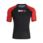 The SMAI Short Sleeve Rash Guard - Red features a black body, red sleeves, and "SMAI" printed boldly on the chest—ideal for no-gi grappling sessions.