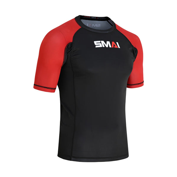 The SMAI Short Sleeve Rash Guard - Red features a black body, red sleeves, and a white "SMAI" logo on the chest. Designed for no-gi grappling, it offers advanced compression technology for optimal athletic performance.