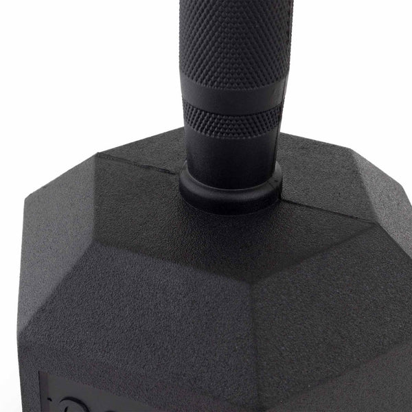 Close-up of the handle and top of a black, hexagonal dumbbell with a textured grip, like the SMAI The Yard - Rubber Hex Dumbbell 32.5kg (Pair) found among quality commercial gym equipment.