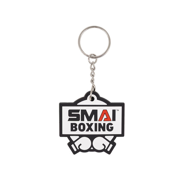 The SMAI Boxing Keyring - Rubber features "SMAI BOXING" text, a boxing gloves graphic, and includes a silver chain and ring—ideal for fans or athletes.