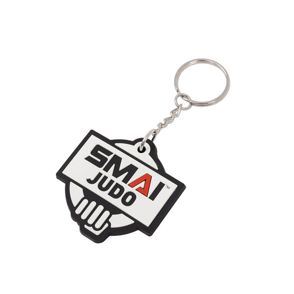 The SMAI Judo Keyring - Rubber features a metal ring and a rubber tag with "SMAI JUDO" printed in bold black and red on a white, black-edged background.