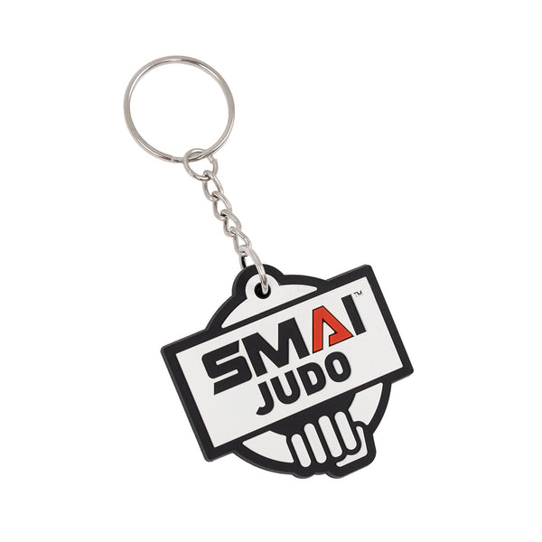 The SMAI Judo Keyring - Rubber by SMAI features a metal ring and chain, with a rubber emblem showing "SMAI JUDO" over a stylized hand gripping a belt, and the letter "A" highlighted in red.