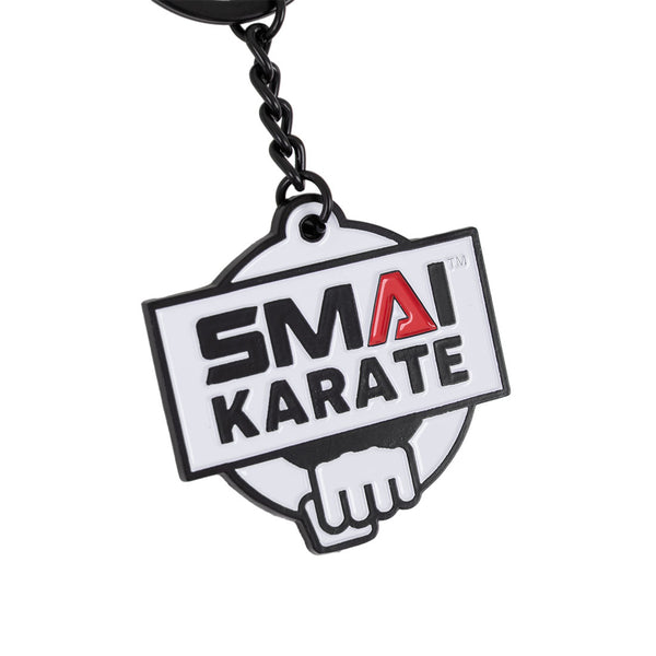 The SMAI Karate Keyring - Metal by SMAI features a rectangular tag with "SMAI KARATE" (red "A", other letters black) above a stylized fist.