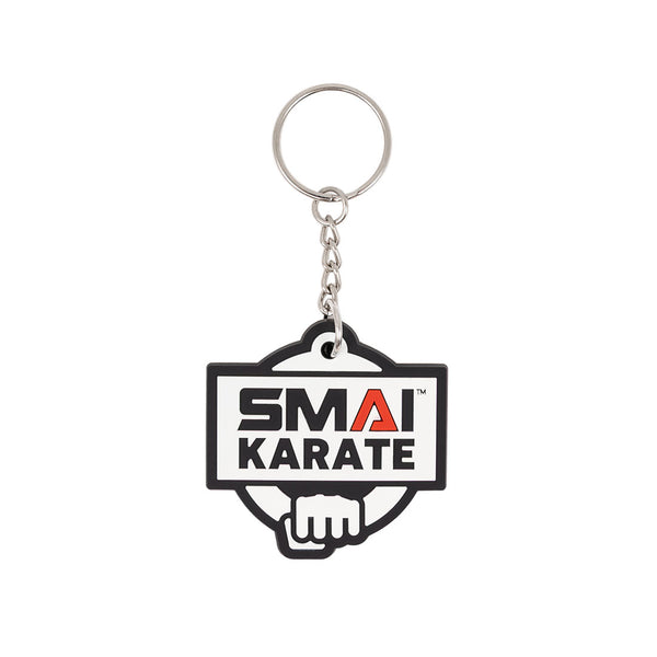 The SMAI Karate Keyring - Rubber by SMAI features a silver chain and rectangular rubber tag with "SMAI KARATE" in black and red above a white fist graphic outlined in black.