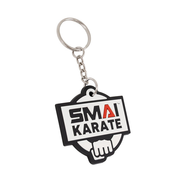 The SMAI Karate Keyring - Rubber features a metal ring with a black and white tag displaying "SMA KARATE," a red stylized "A," and a fist illustration. Brand: SMAI.
