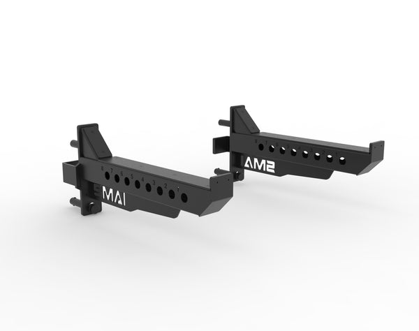 The SMAI Vanta Series Safety Spotting Arms (Pair) are black metal adjustable brackets with multiple positioning holes and a quick-release safety pin system, designed for secure barbell protection. Displayed against a plain white background.