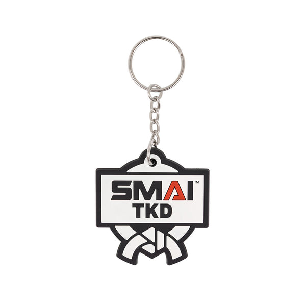 The SMAI Taekwondo Keyring - Rubber features a rectangular SMAI TKD logo with a martial arts belt design, attached to a sturdy metal ring and chain.