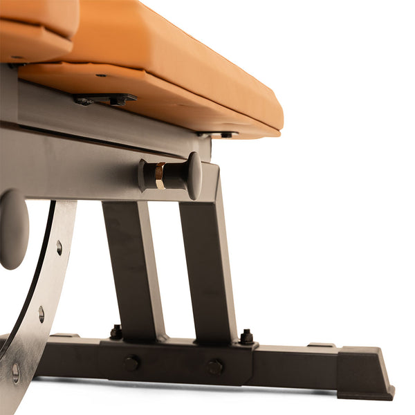 A close-up of the durable black metal frame and tan padded seat of the SMAI Commercial Adjustable Bench, shown against a white background.