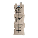 The Makiwara, a large canvas sand bag by SMAI, resembles a plant watering bag with labeled text and multiple channels. It includes metal grommets at the top for hanging and provides guidance for center perch, east, west, high moisture, and low moisture areas.