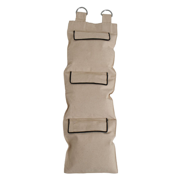 The SMAI Makiwara, a large canvas sandbag with guides, features a tan fabric design with four pockets outlined in black and two metal rings at the top for hanging, making it versatile enough to double as a striking target.