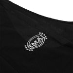 Close-up of the Black Singlet by SMAI, showcasing white embroidered "SMAI USA 1995" text and logo surrounded by stars on black mesh fabric.