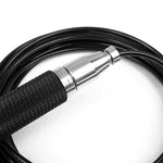 Close-up of the Speed Rope - Premium Black Steel by SMAI, showcasing its black coiled cable with a textured grip, silver metal connector, and thin wire. Utilizing German bearing technology, the cable is elegantly wrapped in a circular pattern on a white background.