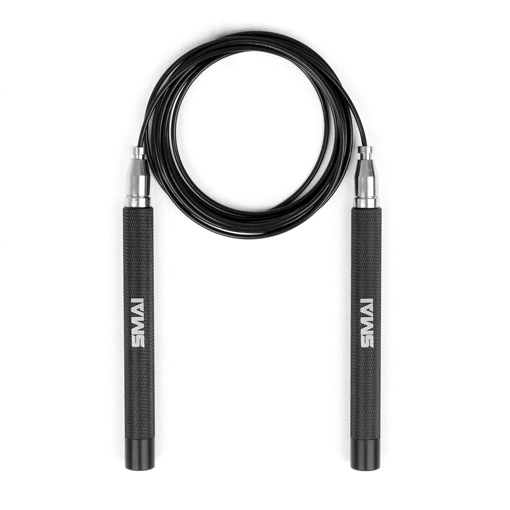 A Premium Black Steel speed rope with textured handles and German bearings is coiled in a circle against a white background. The word "SMAI" is printed on each handle.