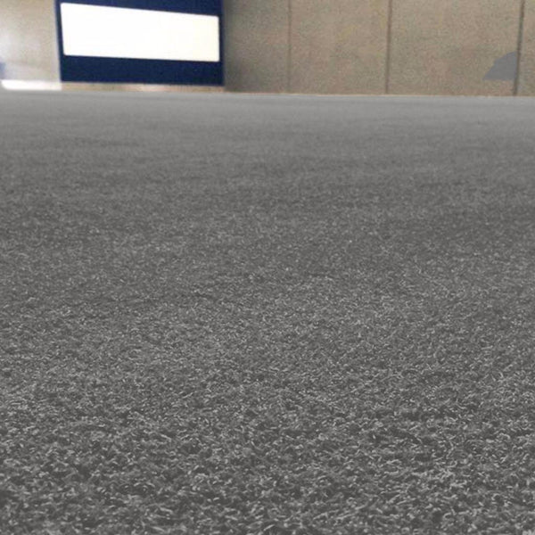 Low-angle view of a spacious indoor area featuring SMAI's Grey Sled Turf Track (2m x 20m) with gym flooring, gray carpet, beige walls, and a white rectangular zone on a dark blue background—perfect for commercial use.