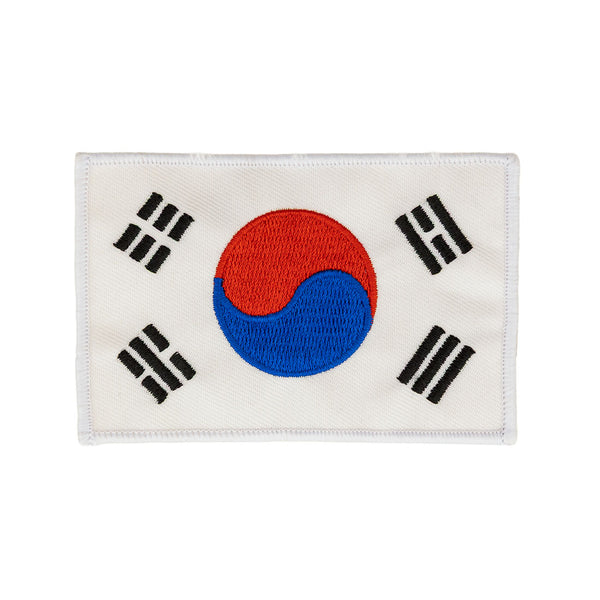 The SMAI Badge - Korean Flag features a rectangular embroidered design with the red and blue yin-yang center, four black trigrams on white, and is perfect as an iron-on addition to your collection.