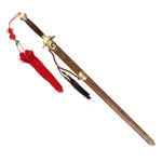 The SMAI Tai Chi Sword Brass Fitting Ying Yang features a spring steel blade, a wooden scabbard with gold brass fittings and ornate carvings, and a red tassel with knot on the handle.