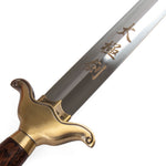 A close-up of the SMAI Tai Chi Sword Brass Fitting Ying Yang, featuring a golden brass guard, wooden handle, and Chinese characters engraved on its polished spring steel blade.