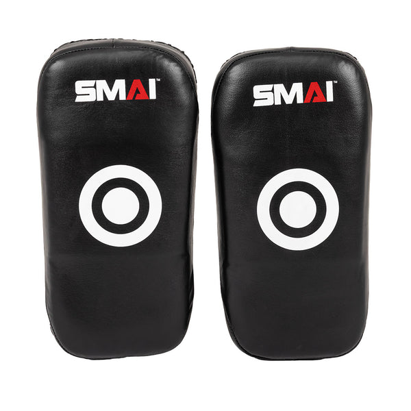 The SMAI Muay Thai Pad - Syntec Black (Pair) features two black rectangular pads with white target circles and the "SMAI" logo on top, made from durable synthetic leather, shown upright side by side against a white background.