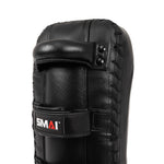 A close-up of the SMAI Muay Thai Pad - Syntec Black (Pair) shows black synthetic leather, visible stitching, a top handle, and a lower strap with the SMAI logo.