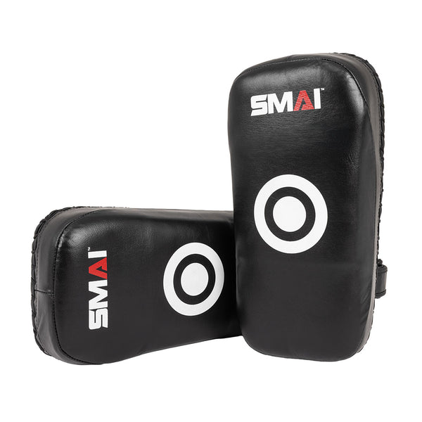 The SMAI Muay Thai Pad - Syntec Black (Pair) features black synthetic leather with white target circles and SMAI’s red and white logo, shown both upright and flat—ideal for martial arts training.