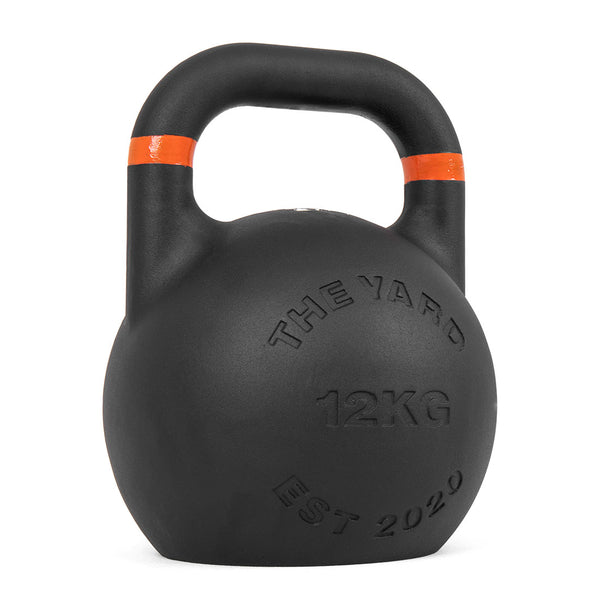 The Yard - Competition Steel Kettlebell 12kg by SMAI features a black finish with an orange stripe and "THE YARD 12KG EST 2020" label—ideal for consistent size and reliable kettlebell workouts.