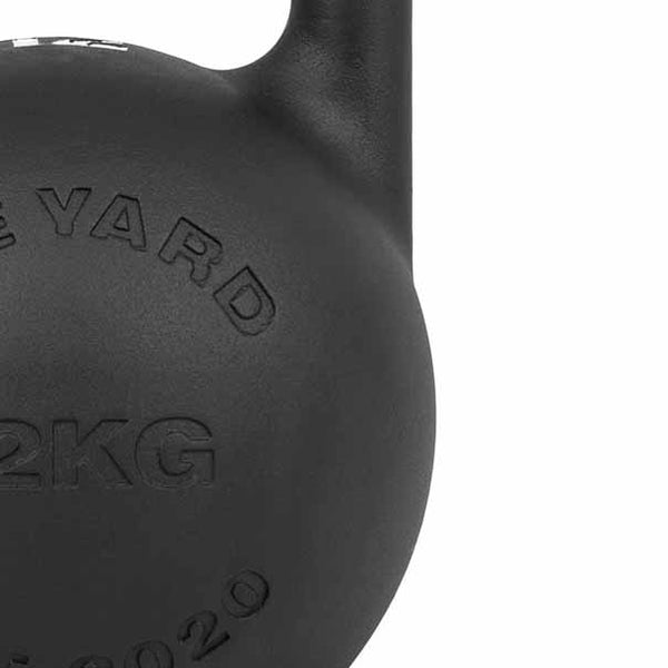 Close-up of a matte black SMAI The Yard Competition Steel Kettlebell 36kg, showing "36KG" and partial custom branding on its upper body and handle.