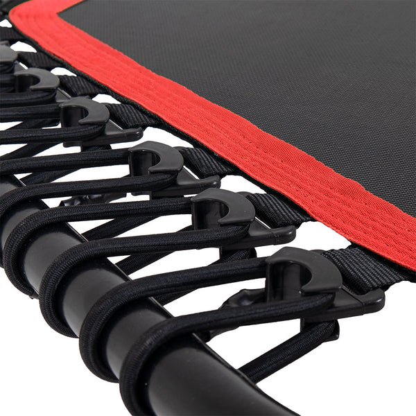 Close-up of the SMAI Rebounder Mini Trampoline 50" frame with elastic bungee cords attached to support a black jumping mat featuring a red border.
