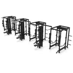 Four black metal SMAI Vanta Series 4 Cell racks with three Lat Pull Towers are arranged in a row, each featuring pull-up bars, weight holders, and cable machine systems—all set against a white background.