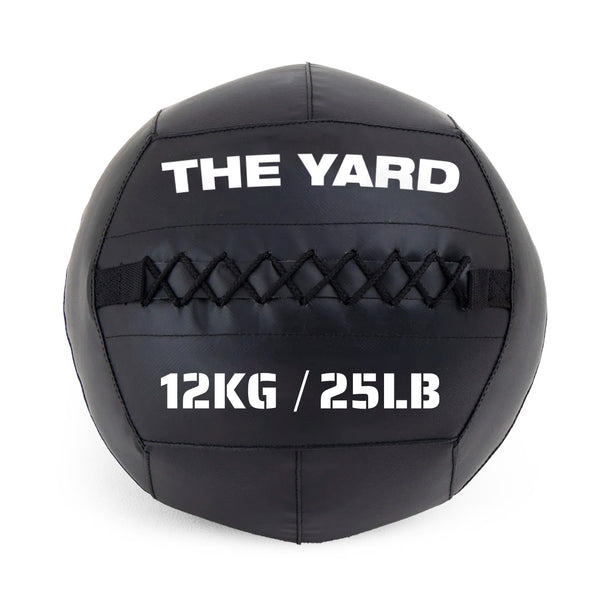 The SMAI The Yard - Wall Ball 12kg features black design, visible stitching, and "THE YARD" with "12KG / 25LB" in white—ideal for intense workouts at The Yard Gym.