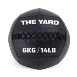 The Yard - Wall Ball 6kg by SMAI is a black gym ball with visible stitching, featuring "THE YARD" at the top and "6KG / 14LB" in bold white text on the front.